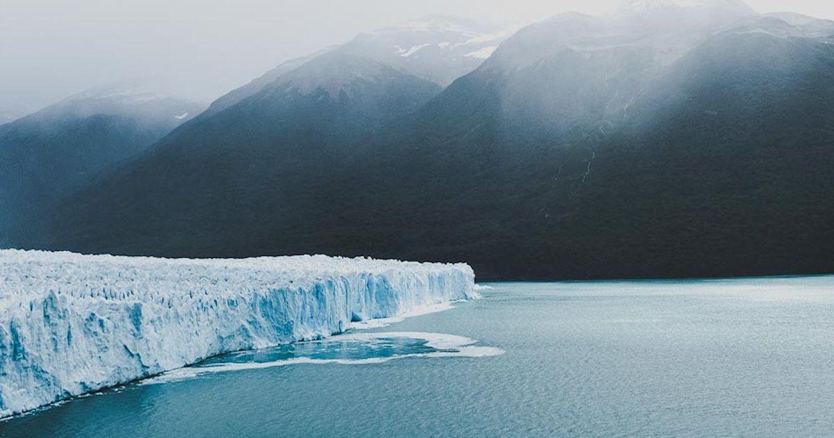 Glacier in Patagonia with misty mountains in the background. Photo by Peru For Less