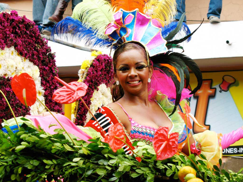 Woman in colorful traditional costume in carnival in Ambato Ecuador. 