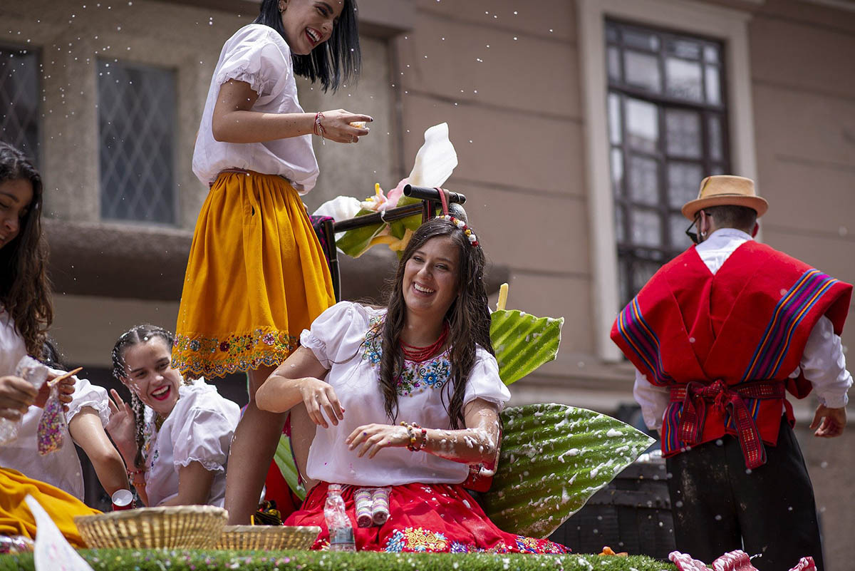 Women in traditional attire during a parade during Carnival festivities. 