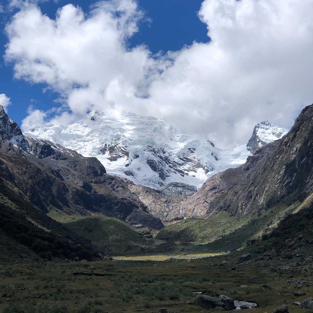 Clouds partially cover snowcapped mountains in huascaran national park, Peru.