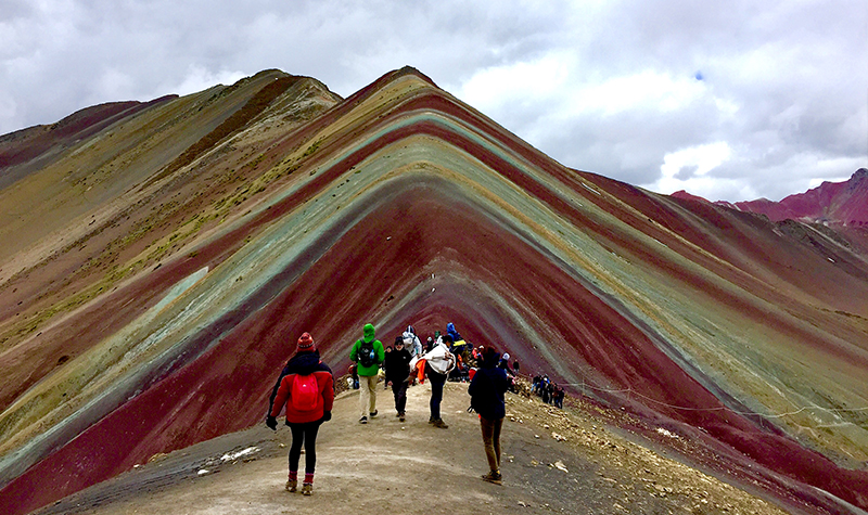 Rainbow Mountain in Peru is striped with red, yellow, and green colored sand.