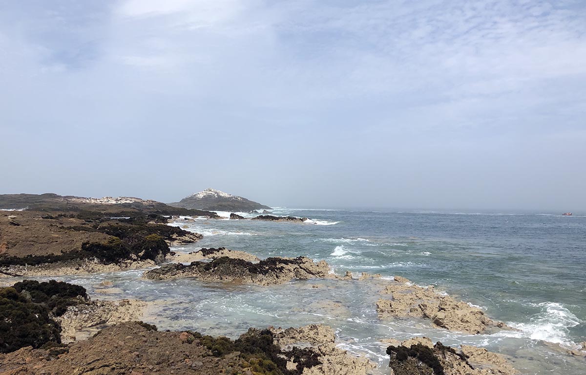 Light turquoise pools are created by lava rock formations at Tuquillo beach in Peru.