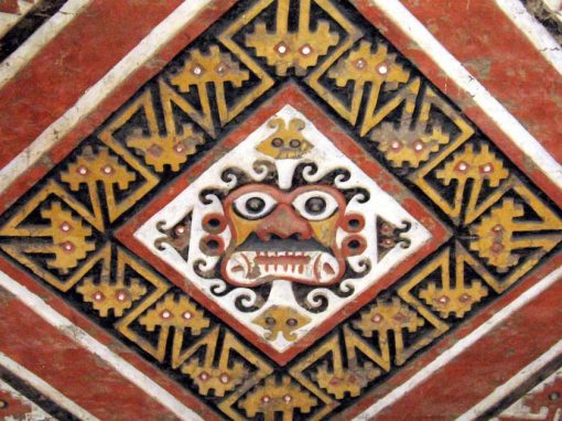A painted wall at the Huaca de la Luna with a face of Ai Apaec, a Moche god, in the center.