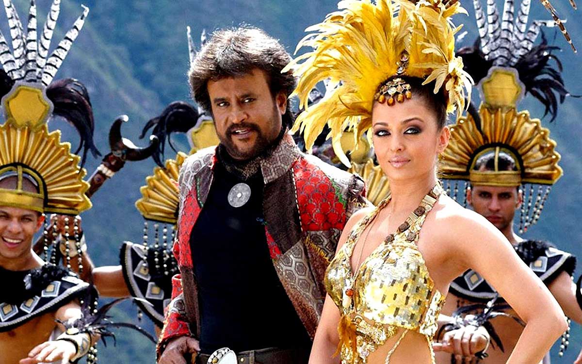 Actors and dancers from a Bollywood film at Machu Picchu wearing gold headdresses and outfits.