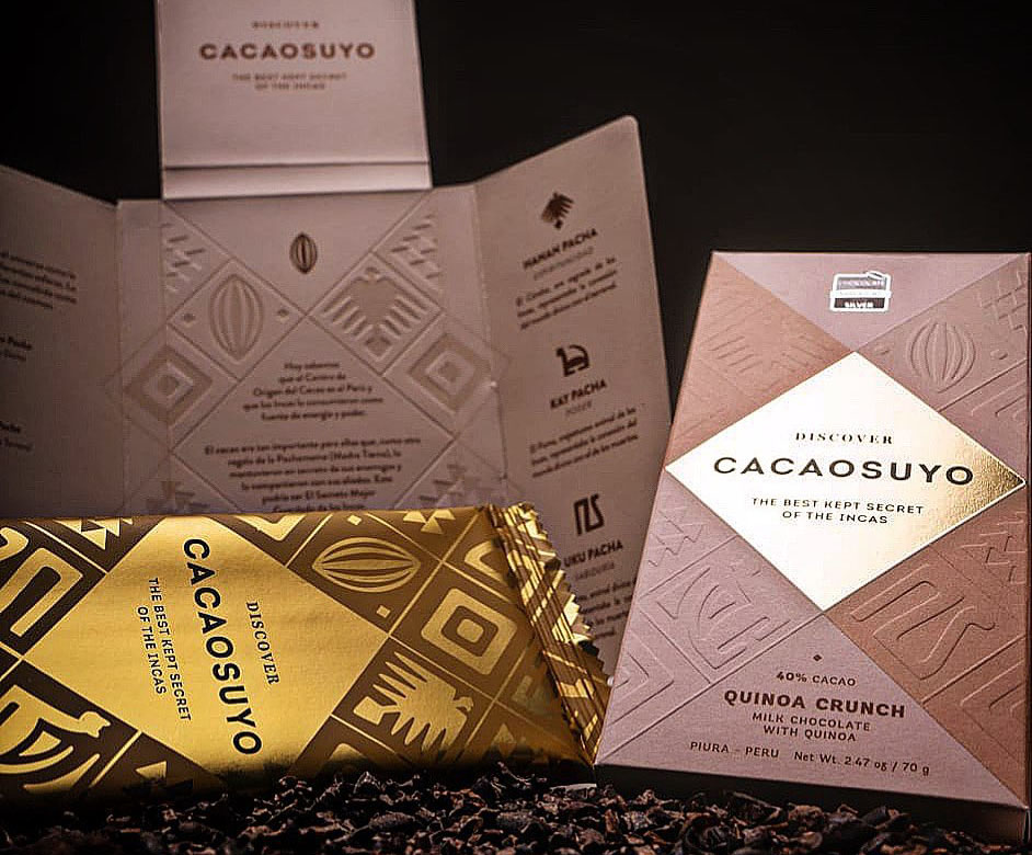 The minimalist cardboard and gold packaging for Cacaosuyo's organic chocolate flavor quinoa crunch.