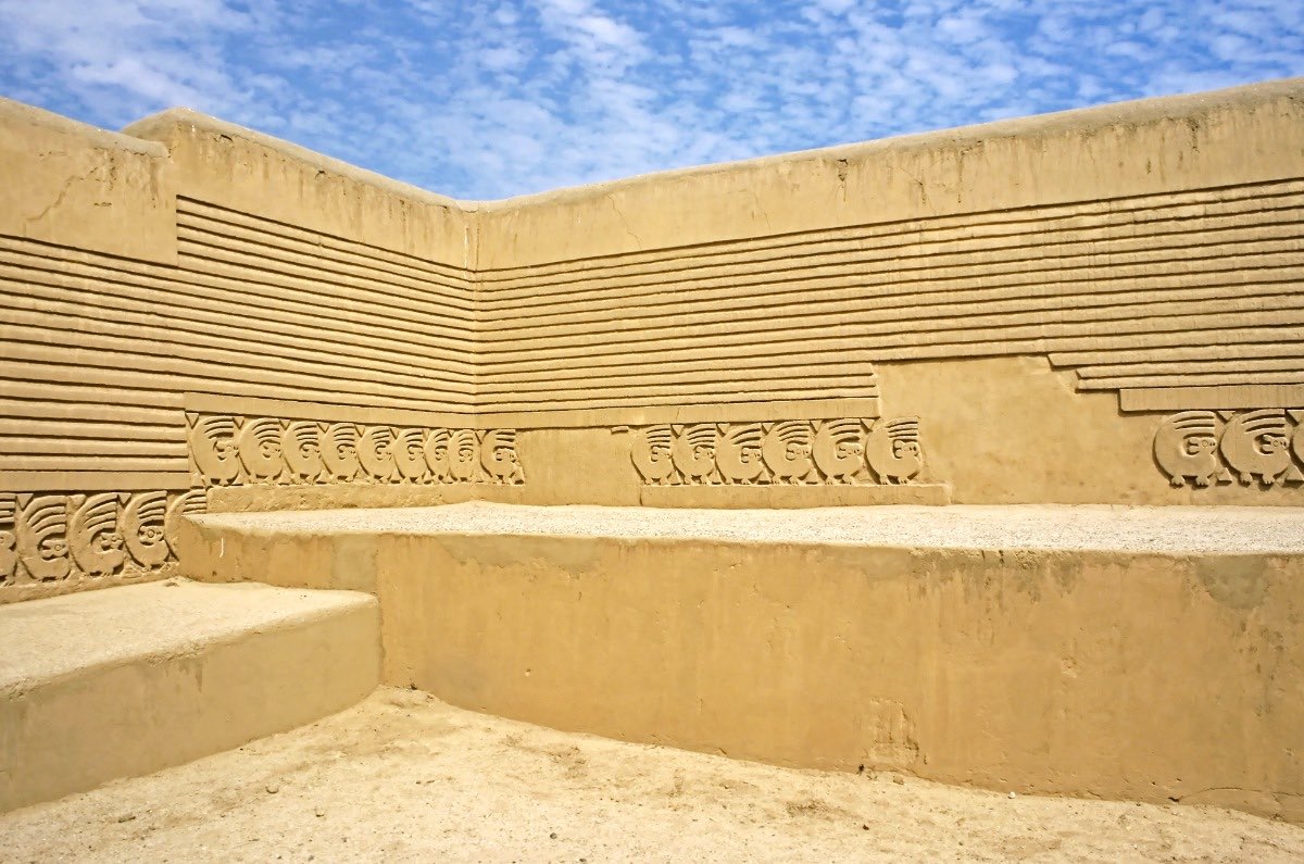 A walls with dozens of geometric relief drawings from the sand-colored ruins of Chan Chan.