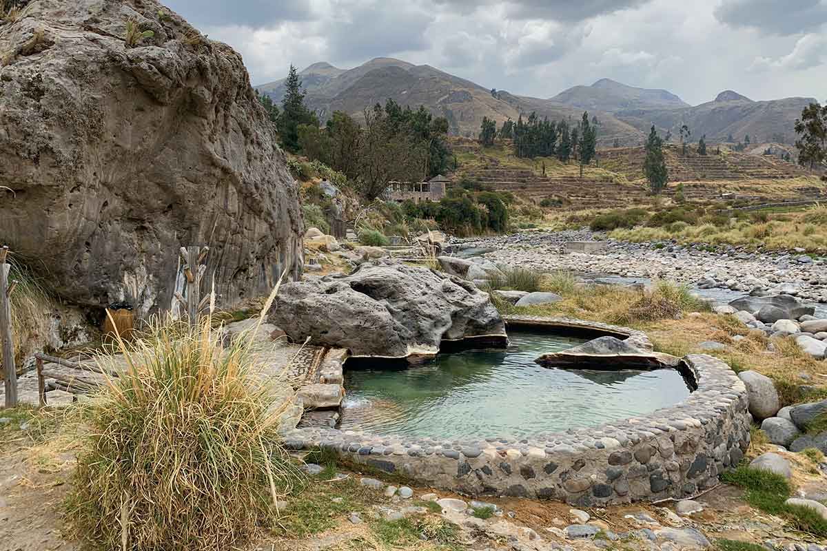 Private hot springs at the Colca Lodge surrounded by mountainous scenery.