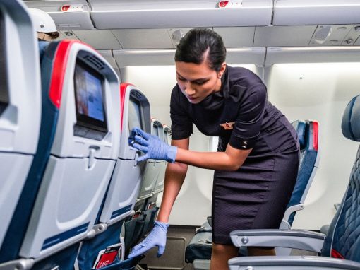 Woman cleans a Delta Airlines plane before the next flight to minimize the spread of Coronavirus.