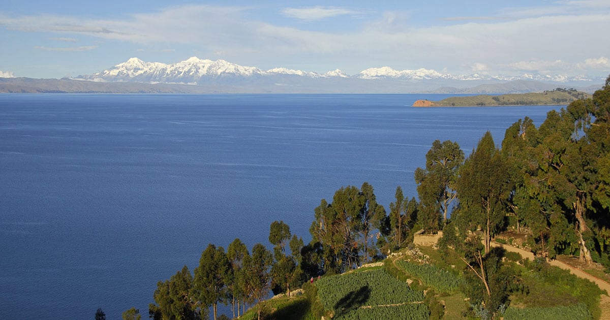 View of Lake Titicaca from Isla del Sol with mountains in background.