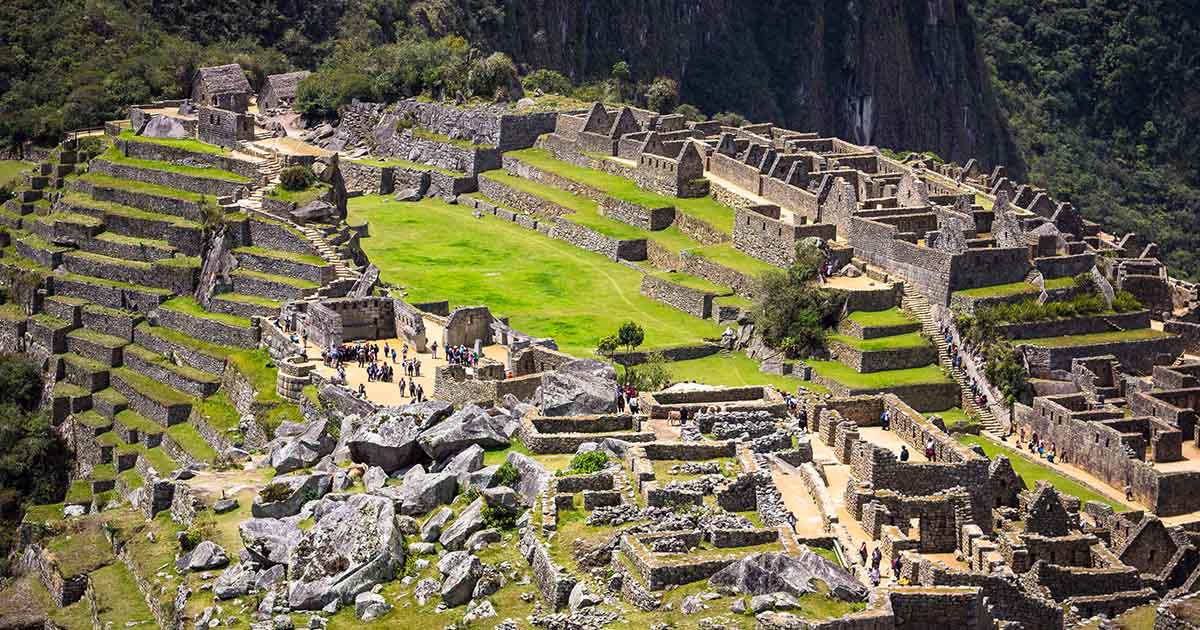 An aerial view of the Machu Picchu ruins on a bright, sunny day.