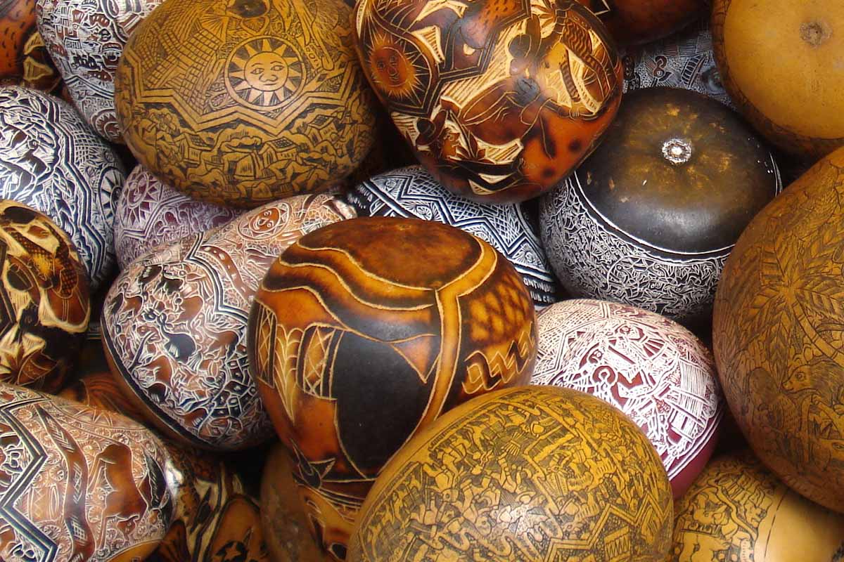 Many hand-carved gourds with very small, intricate designs.