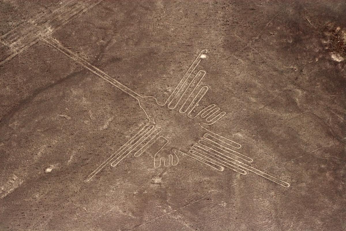 On the desert sand south of Lima in Nazca an ancient geoglyph of a hummingbird lies preserved.