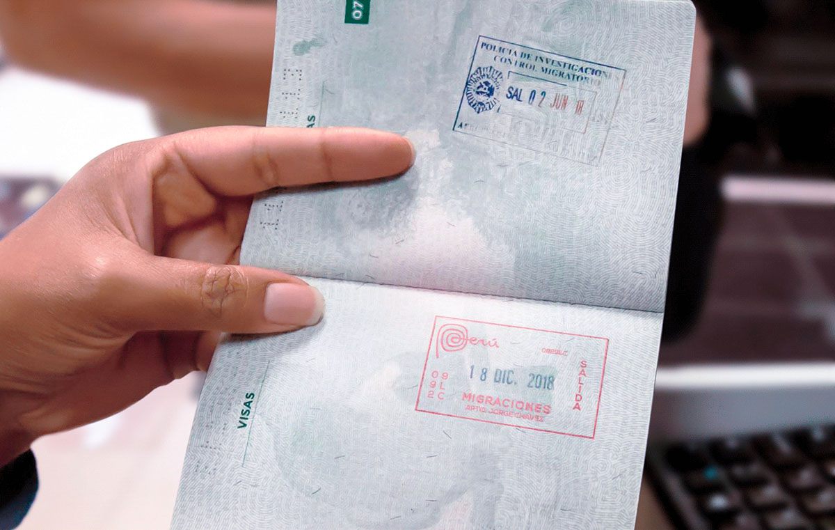 Passport open to the visas page with a Peruvian passport stamp.