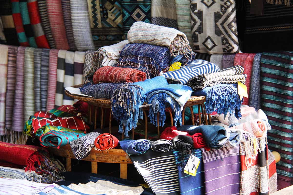 Scarves made out of alpaca wool in a Peruvian market. Colors include white, blue, red and purple.