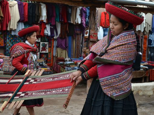 A native Quechua woman showing off a traditional Peruvian textile in the Sacred Valley.