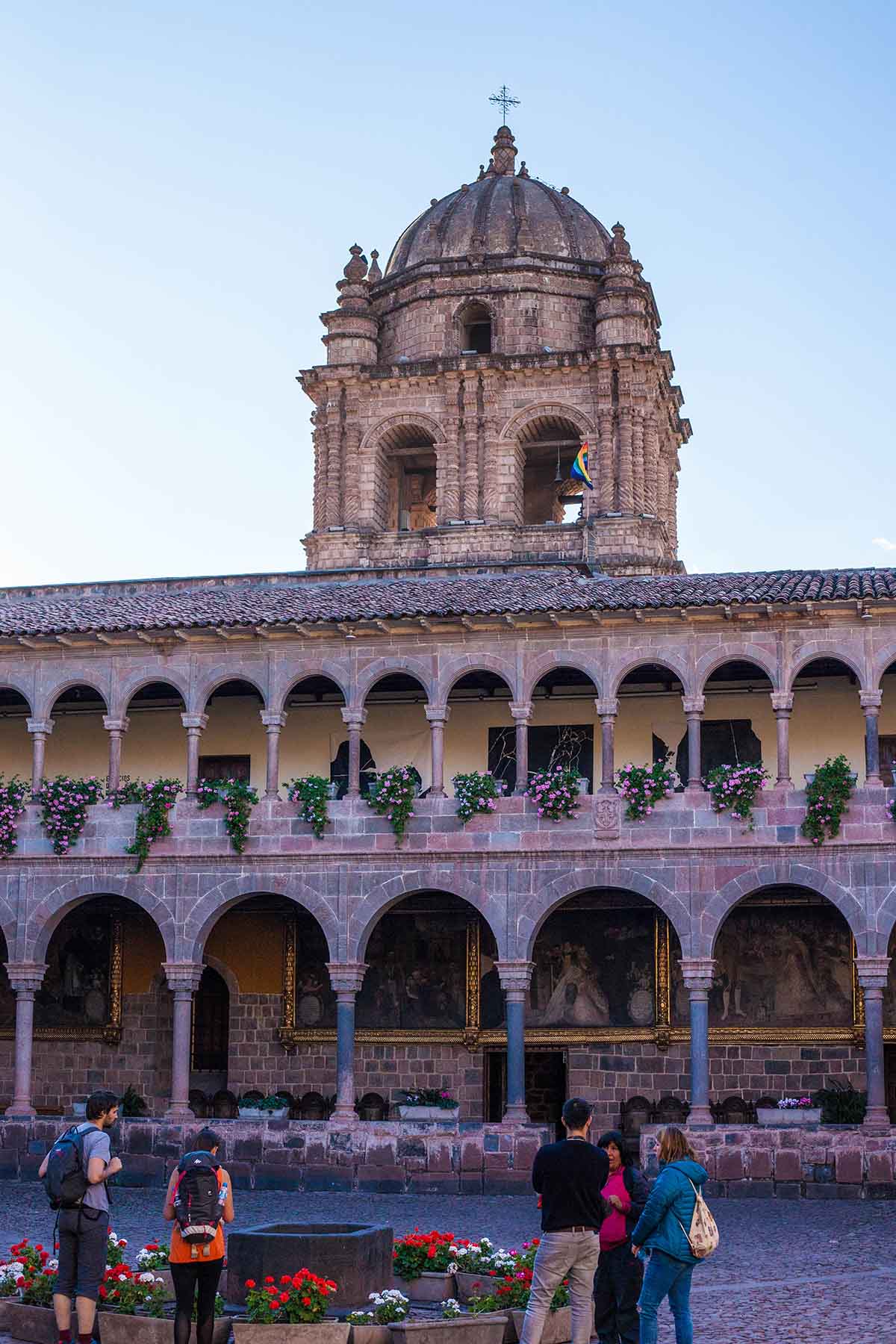 Two stories of arcaded paths surround the courtyard of the stone Santo Domingo church.