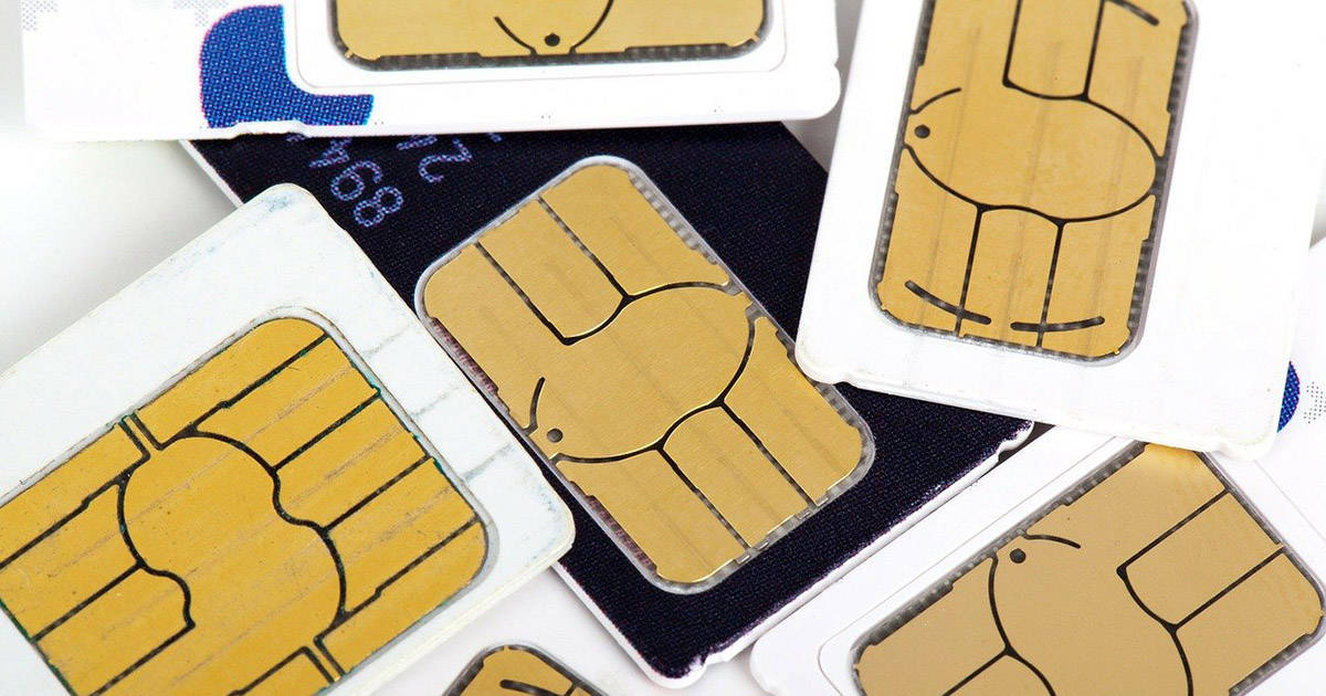 A pile of different sim cards for cell phones.