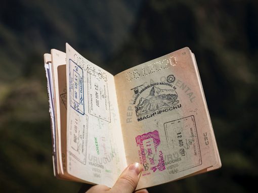 holding an open passport with south america stamps in it