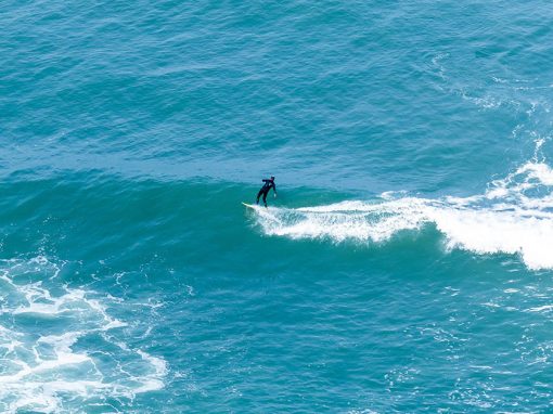 A surfer catching some waves in the water off the coast of Lima, the capital of Peru.